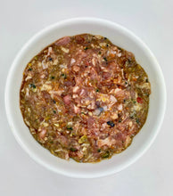 Load image into Gallery viewer, Carolina Wild raw dog food in white bowl against a white background. Visible in bowl a mixture of chicken, fruit, vegetables.
