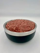 Load image into Gallery viewer, Tiger’s Choice, raw cat food, in black & silver bowl against a white background.
