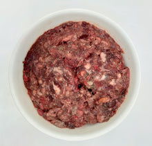 Load image into Gallery viewer, Tripe Organ Meat in a white dog food bowl, a blend of raw: beef heart, tongue, liver, lungs, spleen, pancreas, &amp; green tripe.
